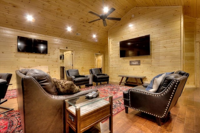 home theater with lofted ceiling, ceiling fan, wood ceiling, and wooden walls