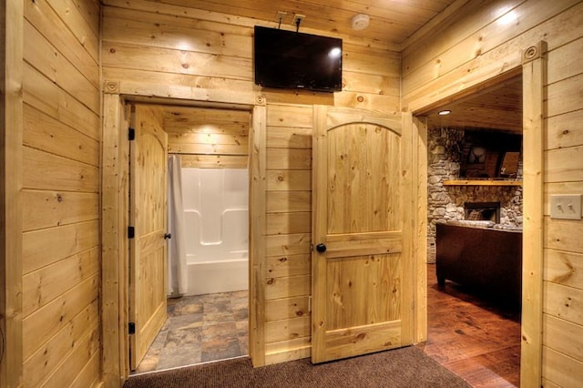 bathroom featuring wood walls