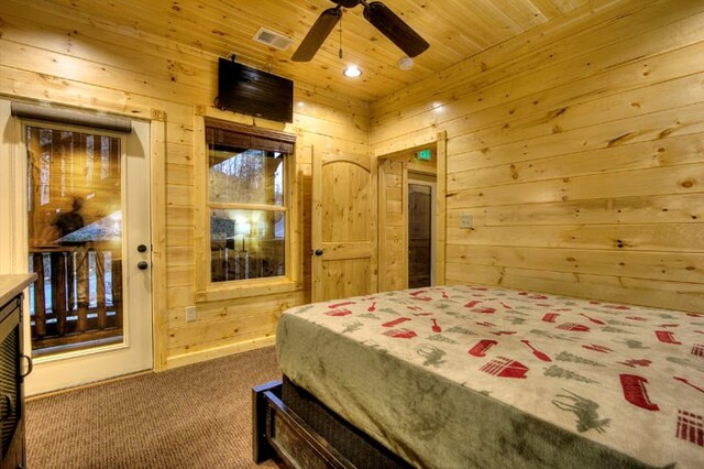 bedroom featuring ceiling fan, wood walls, carpet floors, and wooden ceiling