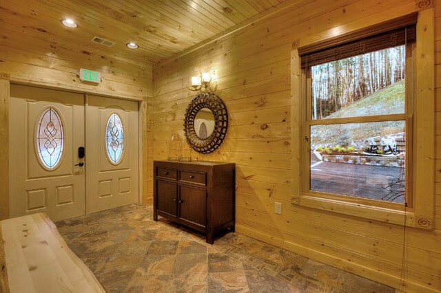 entryway with wood ceiling and wood walls