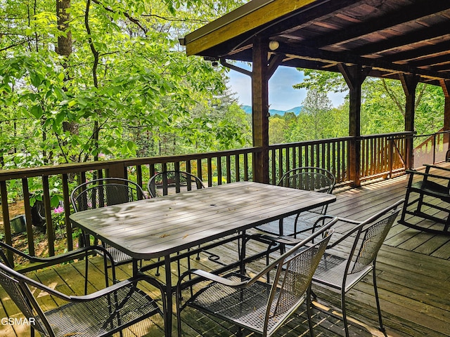 wooden terrace with outdoor dining space
