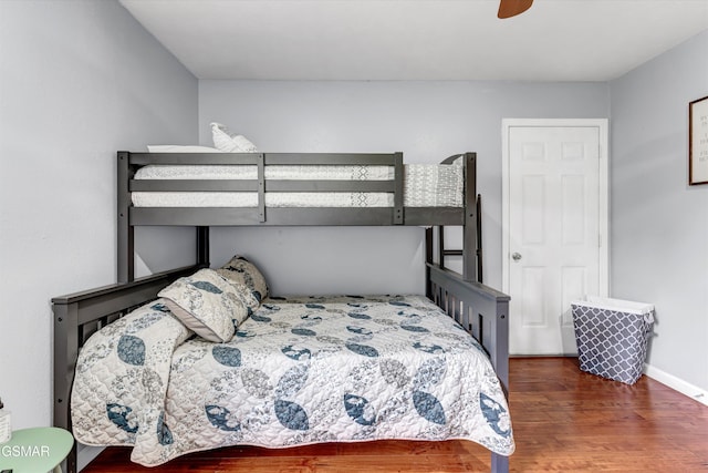 bedroom featuring baseboards, a ceiling fan, and wood finished floors