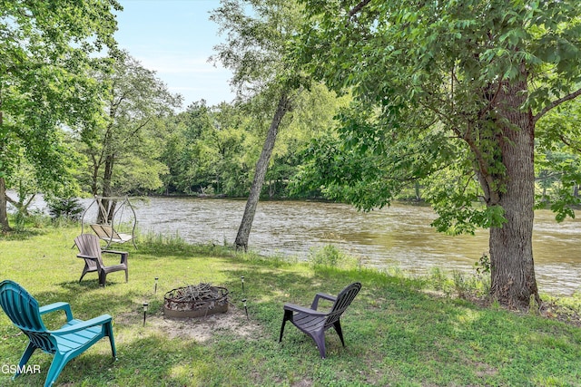 view of yard featuring a water view and a fire pit