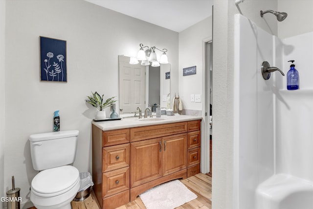 full bath with vanity, toilet, wood finished floors, and a shower