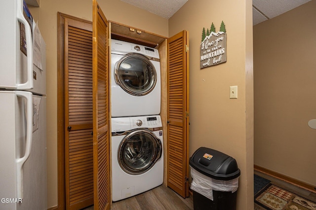 washroom featuring light hardwood / wood-style flooring and stacked washer and clothes dryer