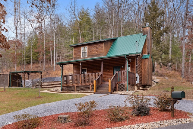 log home featuring a front yard and a porch