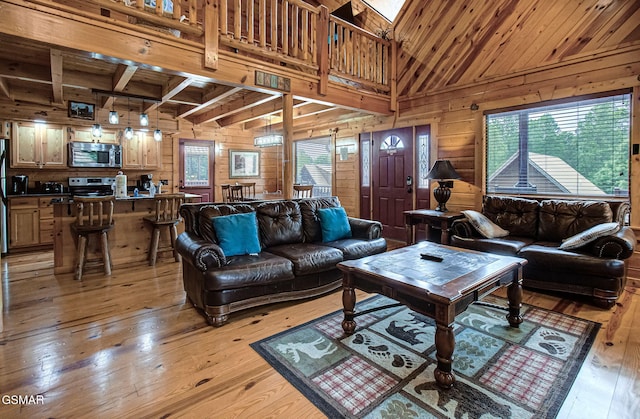 214 Forrest Loop Way, Gatlinburg, TN 37738 - living room featuring wooden walls, light wood-style floors, a skylight, wooden ceiling with exposed beams, and a towering ceiling