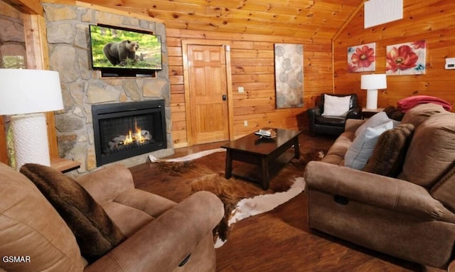 544 Royal Coachman Dr, Pigeon Forge, TN 37863 - living room with lofted ceiling, a fireplace, wooden walls, and wood finished floors