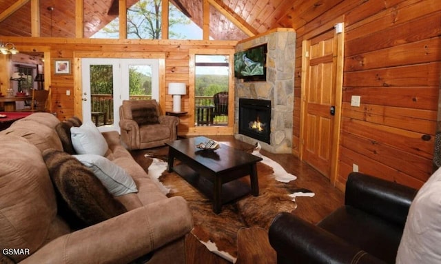 544 Royal Coachman Dr, Pigeon Forge, TN 37863 - living area with wood walls, wood finished floors, lofted ceiling, a stone fireplace, and wooden ceiling