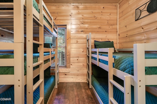 bedroom featuring dark wood-type flooring, wooden ceiling, and wood walls