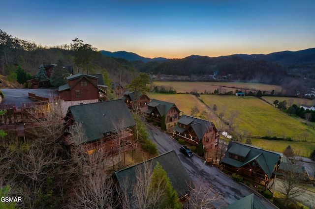 aerial view at dusk featuring a mountain view