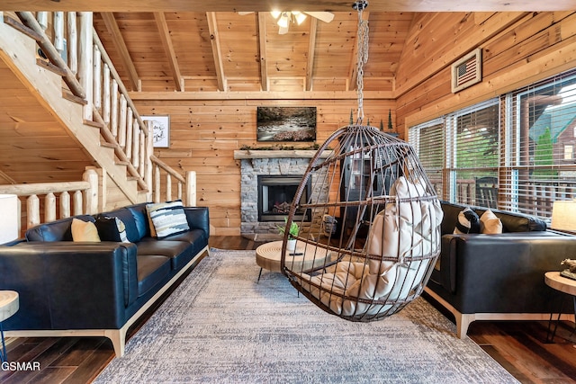 living room featuring beamed ceiling, wooden walls, and wooden ceiling