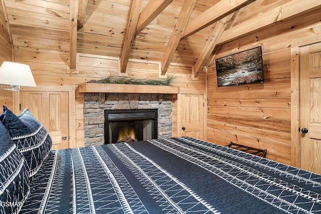 unfurnished bedroom featuring lofted ceiling with beams, wooden ceiling, a fireplace, and wood walls