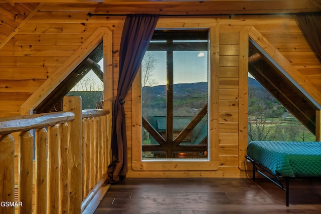 doorway to outside featuring lofted ceiling, wood ceiling, wooden walls, dark hardwood / wood-style flooring, and a mountain view