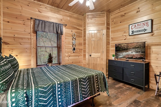 bedroom with wood ceiling, ceiling fan, dark hardwood / wood-style flooring, and wood walls