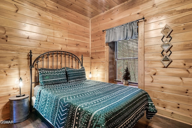 bedroom with wooden ceiling and wooden walls