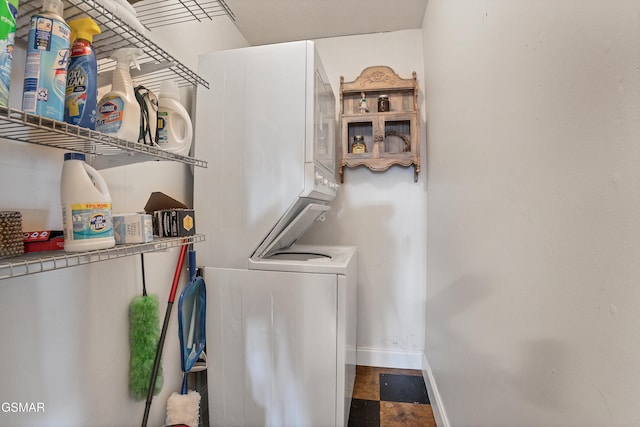 clothes washing area featuring stacked washer / dryer