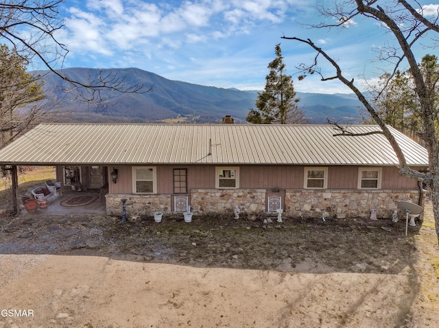 exterior space with a mountain view and a patio area