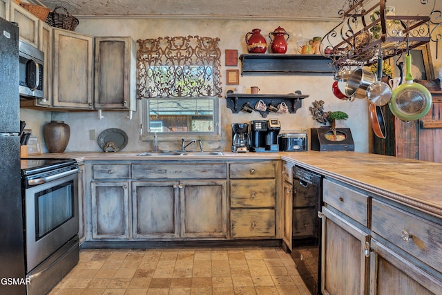 kitchen featuring butcher block counters, appliances with stainless steel finishes, and sink