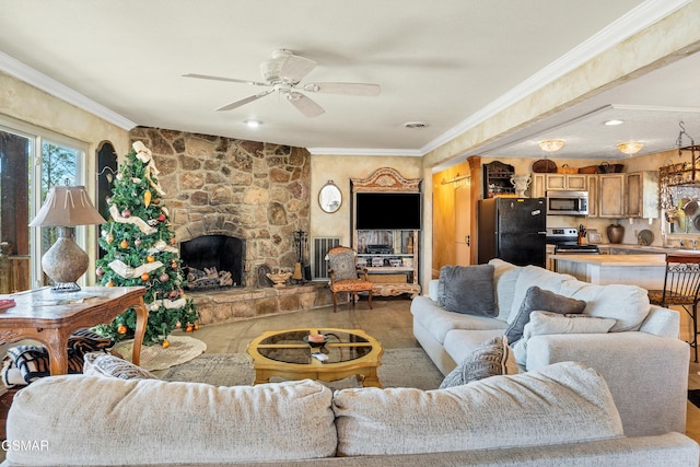 living room with crown molding, a stone fireplace, and ceiling fan