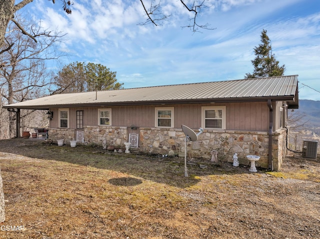 back of property with cooling unit and a lawn