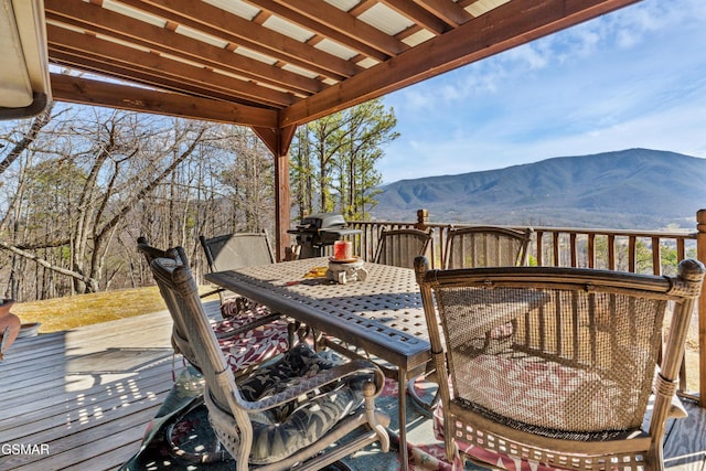 wooden deck featuring area for grilling and a mountain view