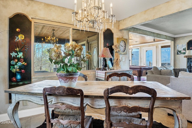 dining space with crown molding and a chandelier