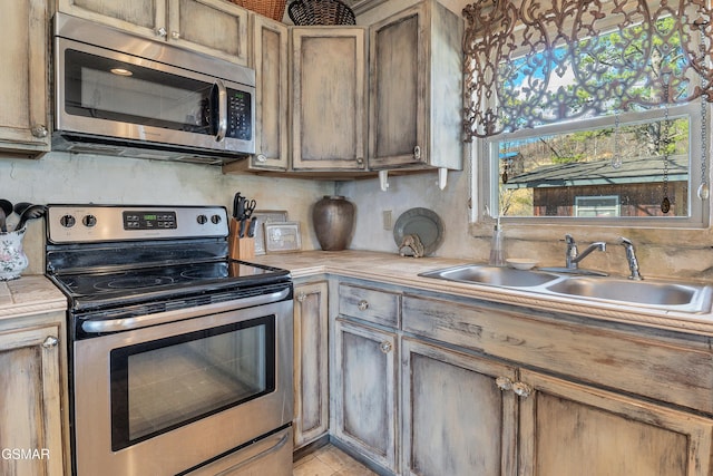 kitchen featuring appliances with stainless steel finishes, sink, and decorative backsplash