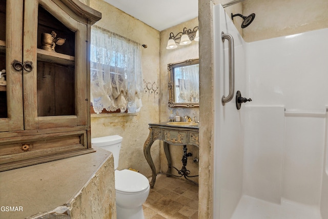 bathroom featuring toilet, sink, and a shower