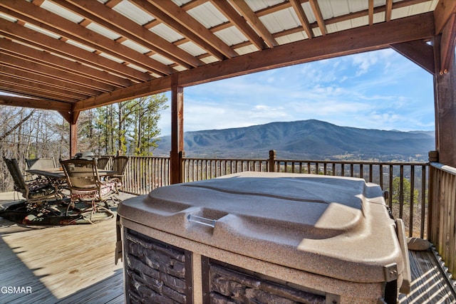 wooden terrace with a mountain view and area for grilling