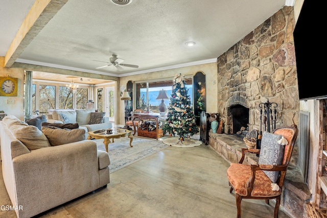 living room with a fireplace, plenty of natural light, ornamental molding, and a textured ceiling