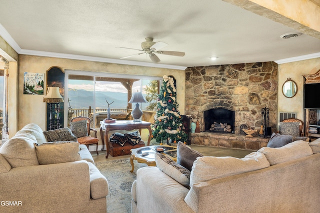 living room with ornamental molding, a textured ceiling, ceiling fan, and a fireplace