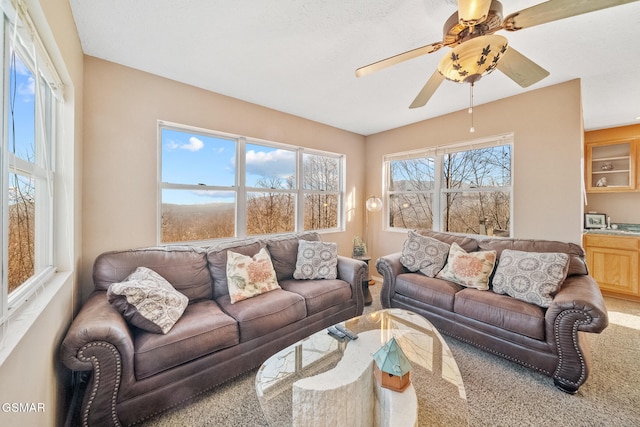 living room featuring carpet flooring and ceiling fan