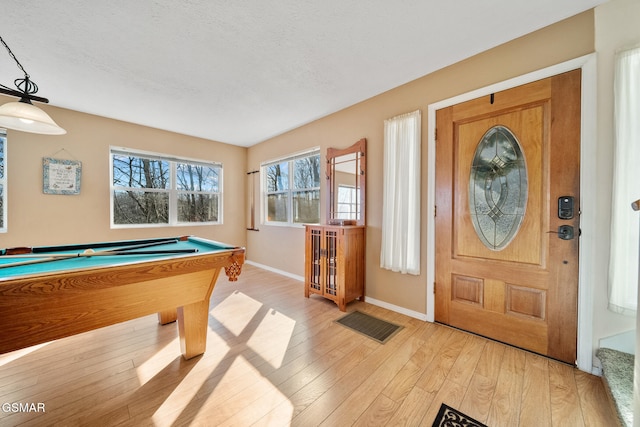 entryway featuring pool table, light hardwood / wood-style floors, and a textured ceiling