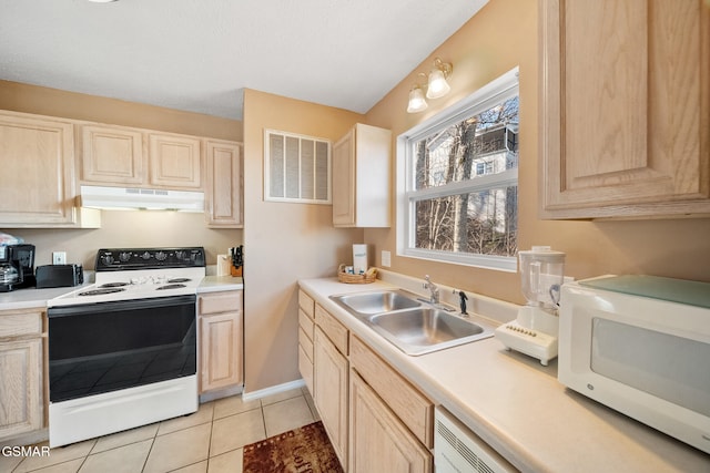 kitchen featuring sink, light tile patterned floors, light brown cabinets, and electric stove