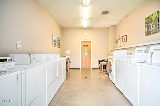 shared laundry area featuring a textured ceiling, visible vents, and washer and dryer