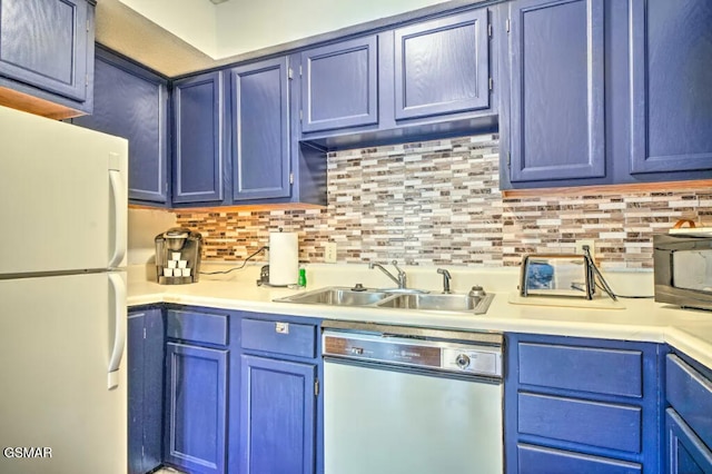 kitchen with a sink, light countertops, blue cabinetry, stainless steel dishwasher, and freestanding refrigerator