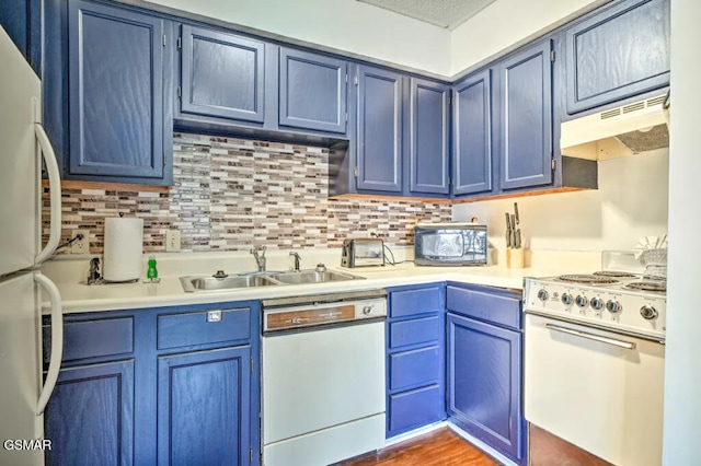 kitchen with white appliances, light countertops, and blue cabinetry