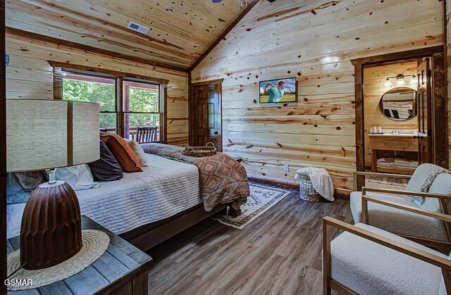 bedroom with hardwood / wood-style flooring, lofted ceiling, wooden ceiling, and wooden walls