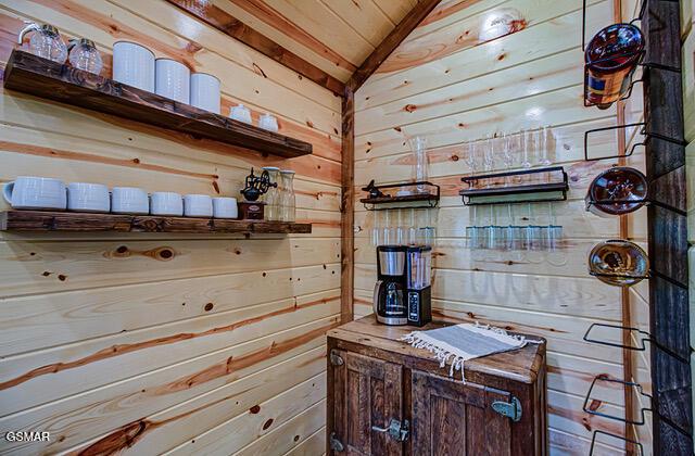 bathroom with wood walls, wood ceiling, and lofted ceiling