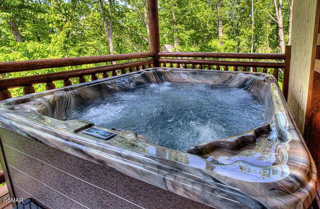 wooden deck featuring a hot tub