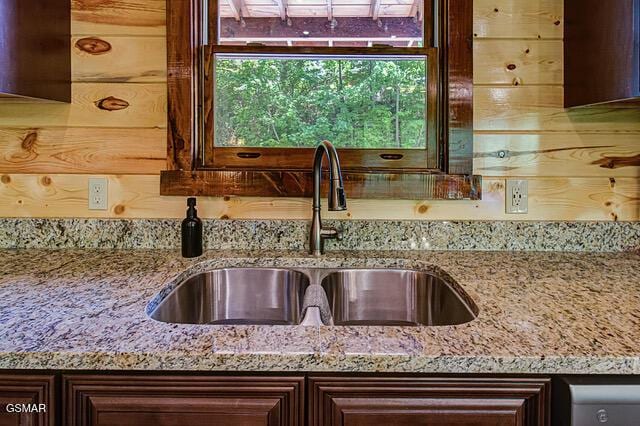 details featuring light stone counters and sink