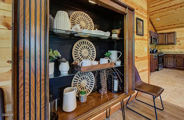 details featuring wood walls, wood ceiling, and stainless steel appliances