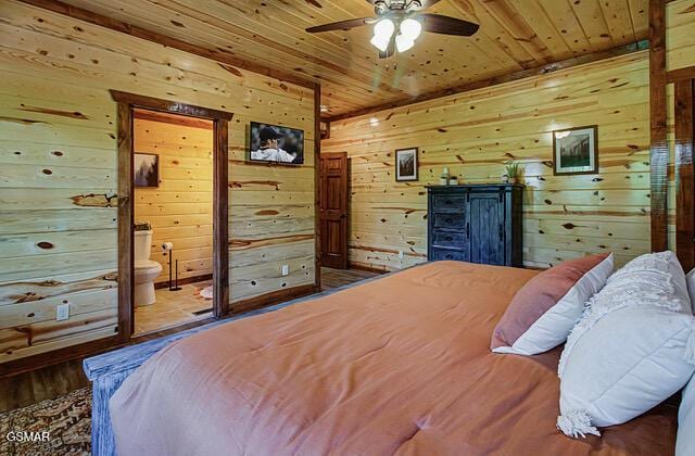 bedroom with ceiling fan, wood-type flooring, wood ceiling, and wooden walls