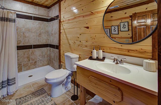 bathroom with a shower with curtain, wood walls, toilet, and wood ceiling