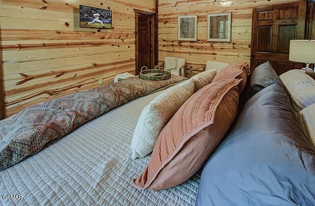 bedroom featuring wood walls