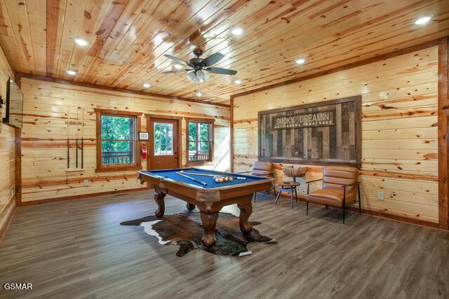 rec room featuring ceiling fan, billiards, dark wood-type flooring, and wooden walls