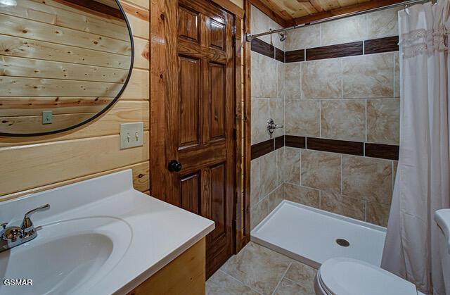 bathroom with wooden ceiling, tile patterned flooring, toilet, vanity, and a shower with shower curtain