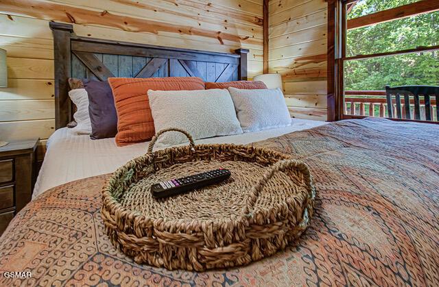 bedroom featuring wood walls