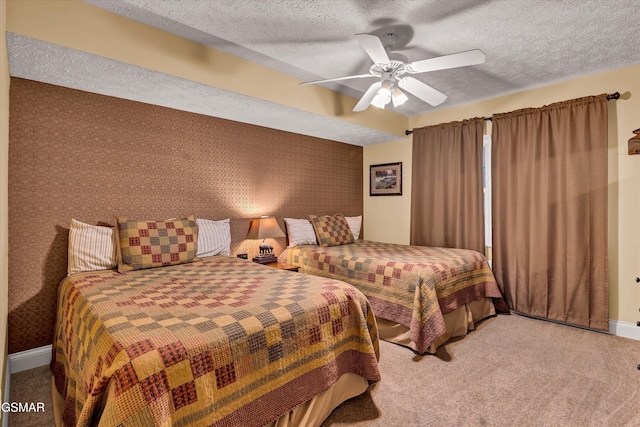 bedroom featuring carpet, ceiling fan, and a textured ceiling